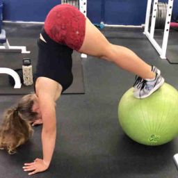 fitness female performing an advanced fit ball peak exercise