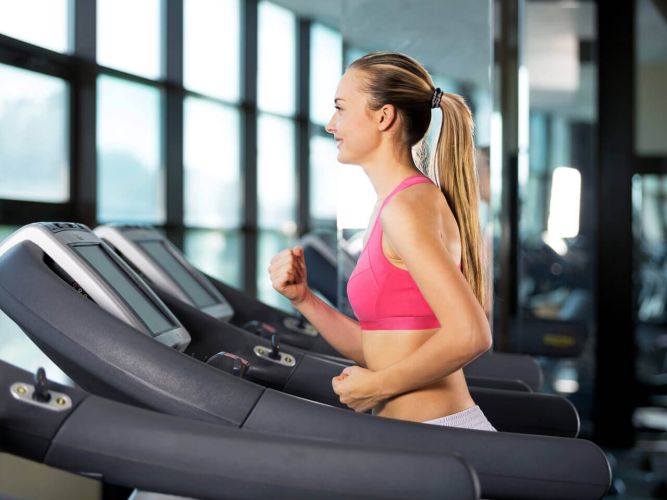 Fitness Girl on Treadmill for cardio training