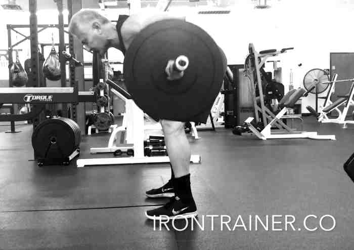 personal trainer demonstrating a bent over barbell row