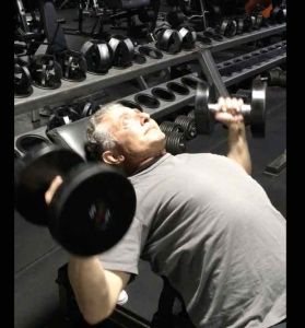 Chest Press Exercise on incline bench pressing dumbbells up