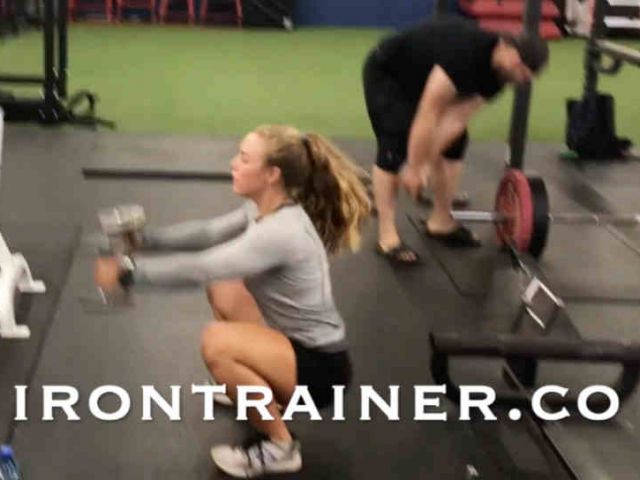 Fitness Trainer Performing Jump Squats