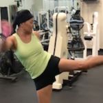 woman kicking a kickboxing pad during training