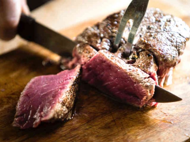 image of rare steak being sliced