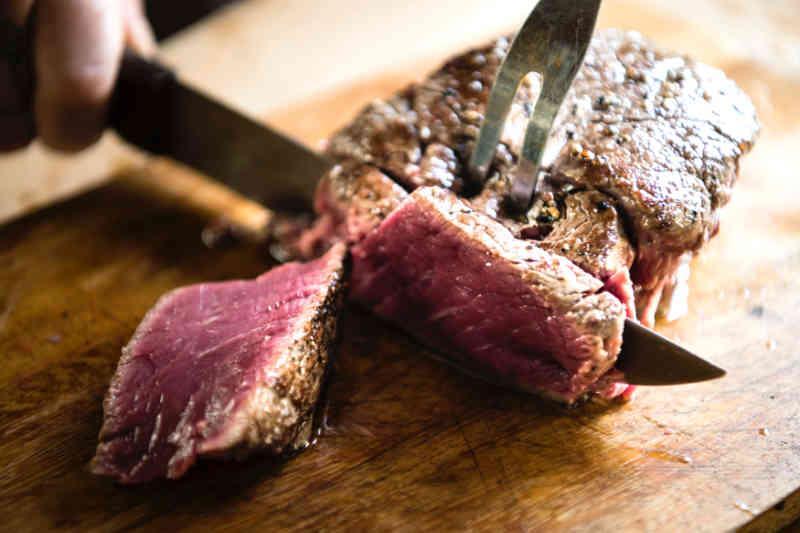 image of rare steak being sliced