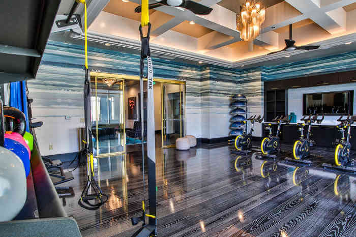 apartment gym with spinning bikes and TRX bands