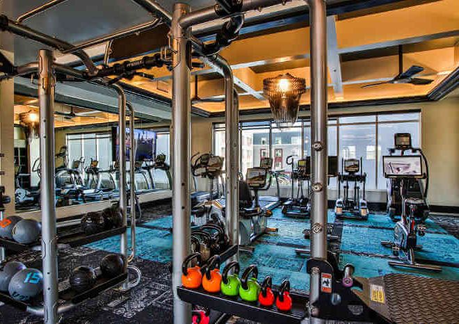 apartment gym with weight equipment and kettlebells