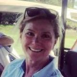 headshot of woman smiling sitting in a golf cart