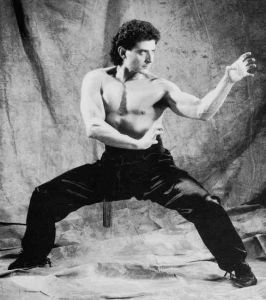 man in martial arts horse stance with hands in tiger claw position