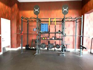 2 olympic racks with olympic bars landmine attachments TRX bands kettlebells