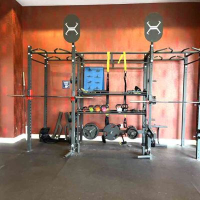 2 olympic racks with olympic bars landmine attachments TRX bands kettlebells