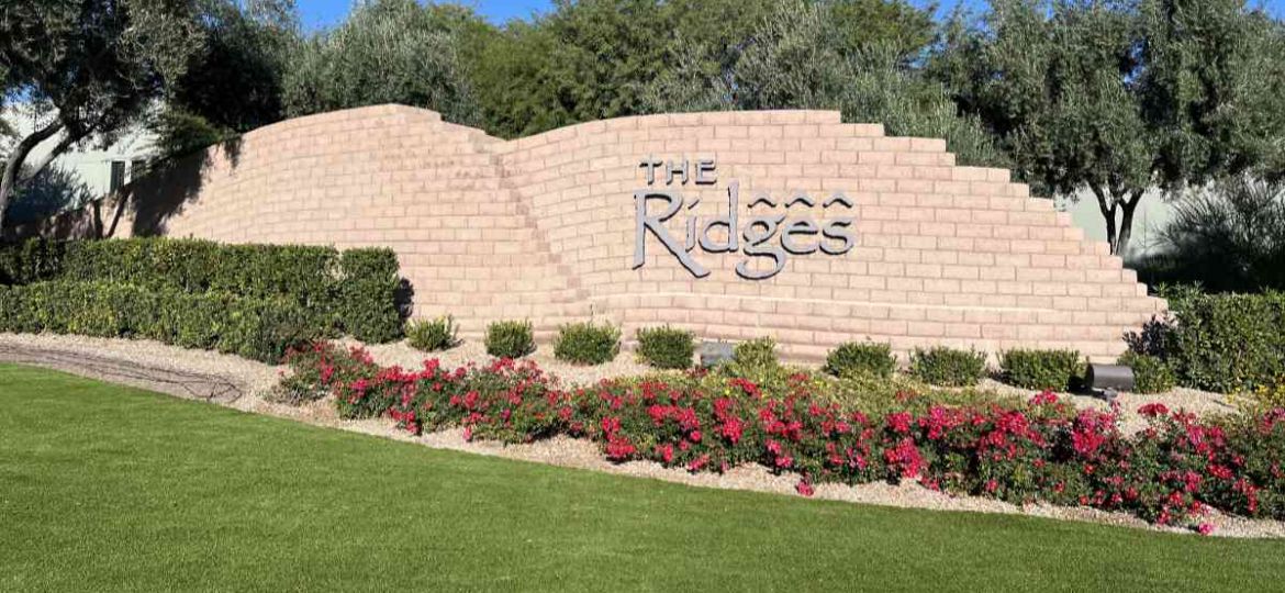 image of the ridges housing community entrance sign letters on a brick wall